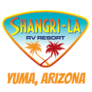 Logo for Shangri-La RV Resort in Yuma, Arizona, featuring two palm trees and bold text on a blue and yellow triangular background.